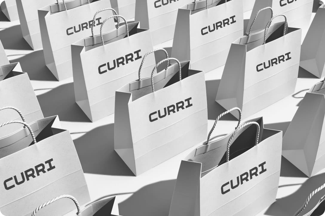 Rows of branded Curri retail shopping bags arranged in a grid, representing modern last-mile retail delivery and fleet logistics.