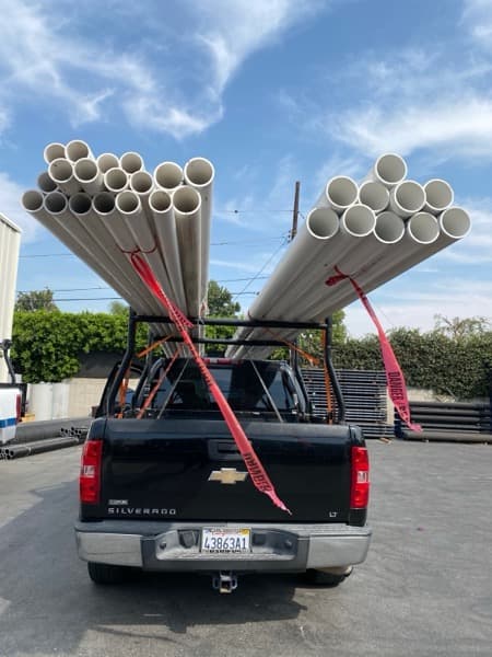 Curri flatbed completing a heavy equipment delivery